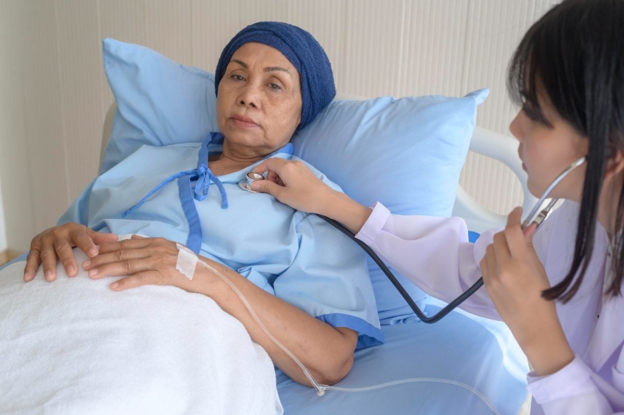 cancer patient woman wearing head scarf after chemotherapy